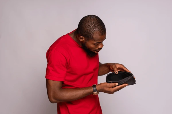 broke-african-man-holding-empty-600nw-2227899711